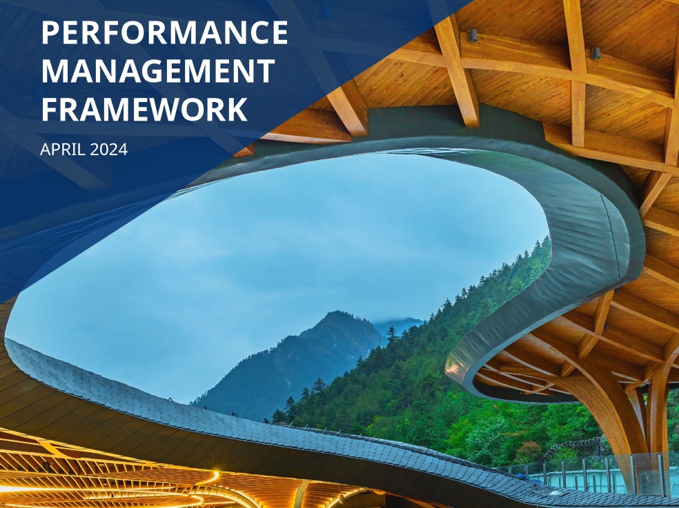 Cover page reads Performance Management Framework April 2024. A mass timber atrium or lobby is shown with a ceiling opening to clear blue skies.