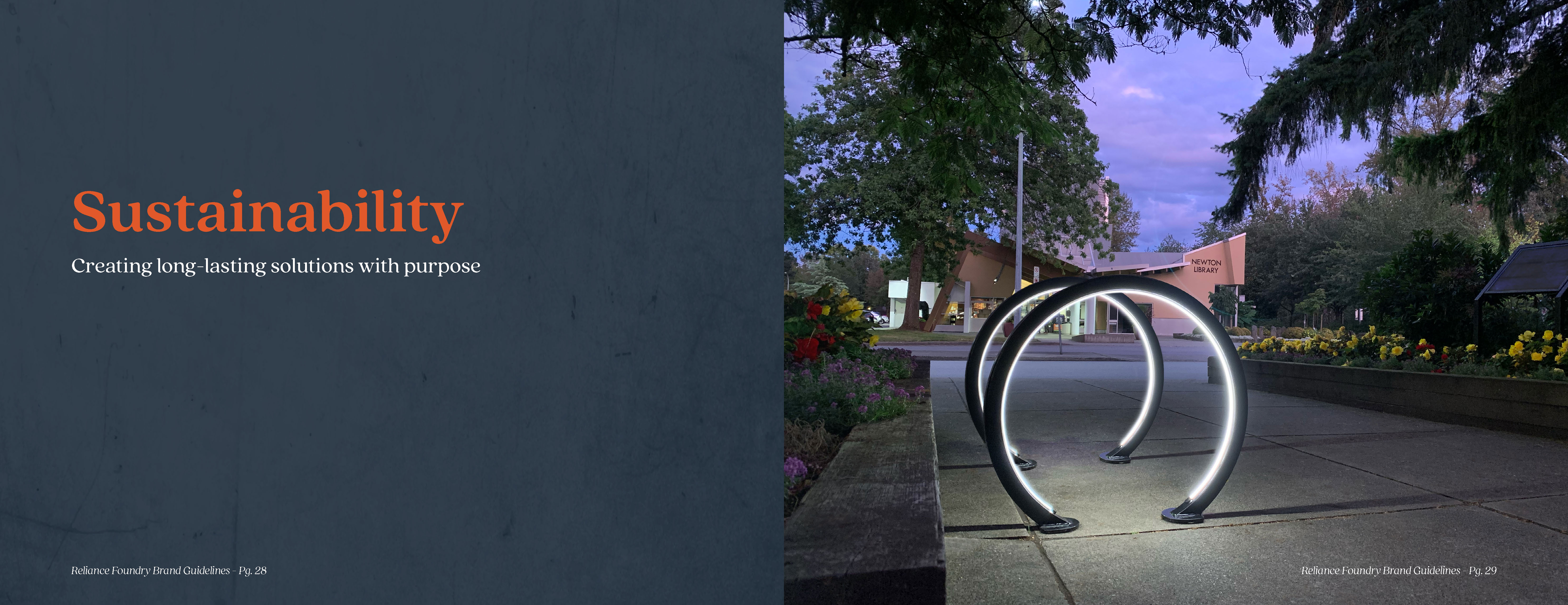 Sustainability. Evening shot of a series of round, lighted bike racks next to flower gardens at a public building.