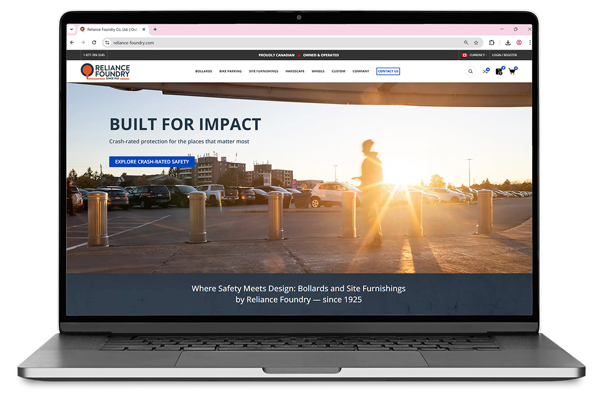 Laptop mockup with Reliance Foundry's web homepage. Hero image shows robust bollards against a shiny sunset whose light filters through a blurry pedestrian.