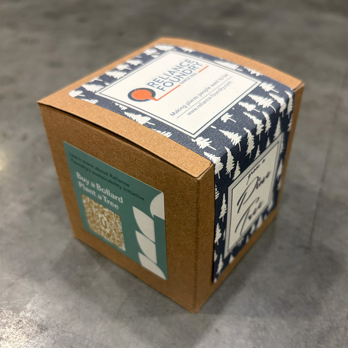 Small brown cubic box with Reliance Foundry's logo, and a sustainability sticker on the side.